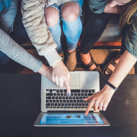 People pointing at the computer screen while choosing an online product