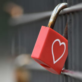 Marketing earned media concept represented by a red padlock with a heart