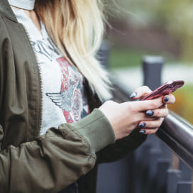 Woman using Russia's most popular social networks on her smartphone